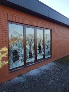 four broken windows in a building
