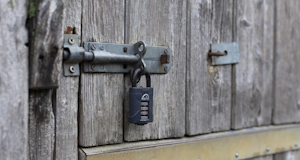 A padlock on a farmhouse door preventing break ins