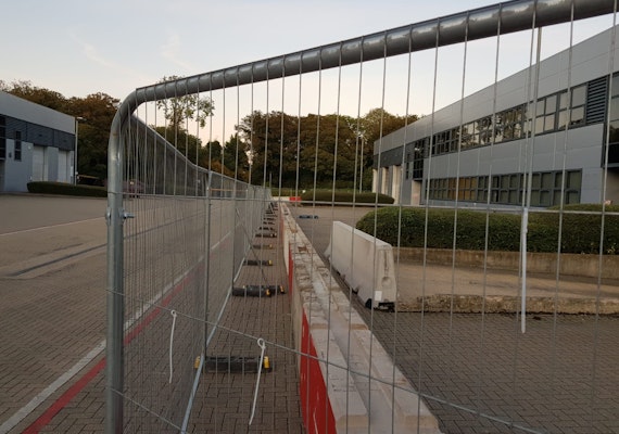 a long row of concrete blocks and fencing in front